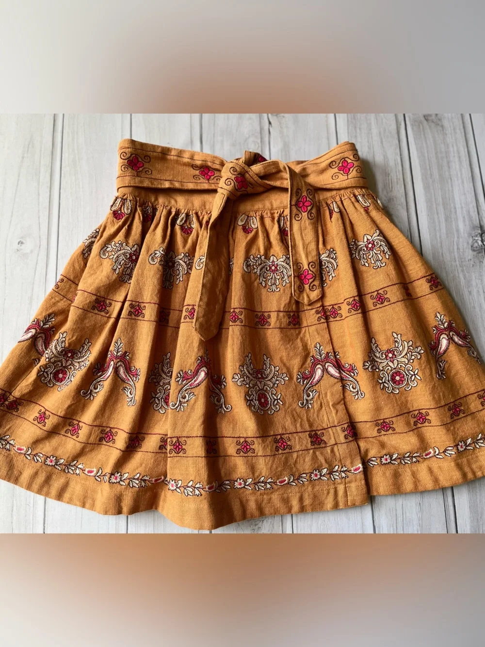 Anthropologie Meghan terracotta embroidered folkloric mini wrap skirt. Size 0